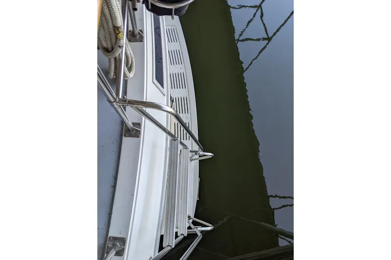 Slide: The Image of 1984 Gulfstar 49 Motor Yacht deck view with railing and water reflection. - 100