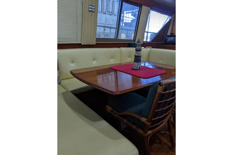 Slide: The Image of Interior of 1984 Gulfstar 49 Motor Yacht with dining area and lighthouse decor. - 102