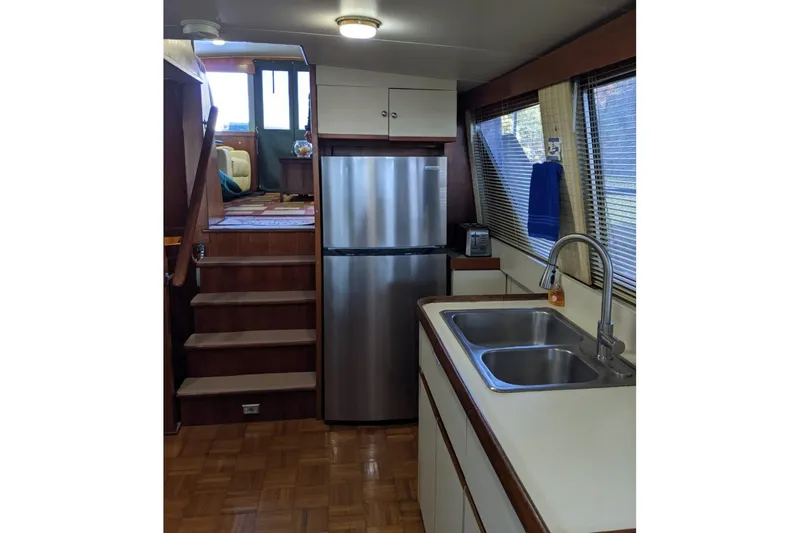Slide: The Image of Interior of 1984 Gulfstar 49 Motor Yacht with kitchen and stairs. - 103