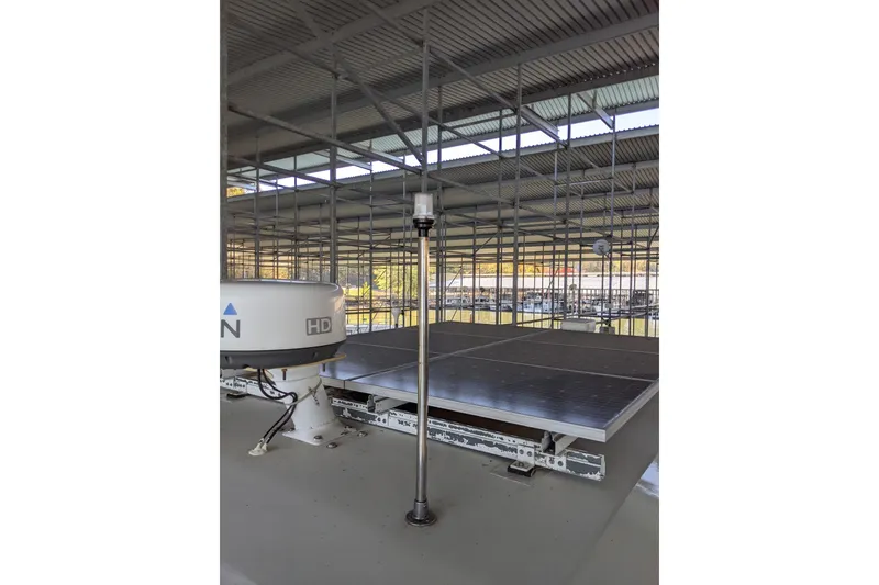 Slide: The Image of 1984 Gulfstar 49 Motor Yacht with solar panels and radar equipment under a covered dock. - 105