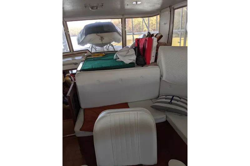 Slide: The Image of Interior of 1984 Gulfstar 49 Motor Yacht with white seating and nautical decor. - 110