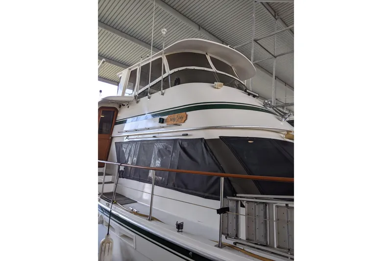 Slide: The Image of 1984 Gulfstar 49 Motor Yacht in a covered dock, showcasing its classic design. - 111