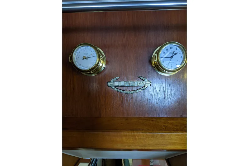 Slide: The Image of Brass clock and barometer on 1984 Gulfstar 49 Motor Yacht wooden panel. - 113