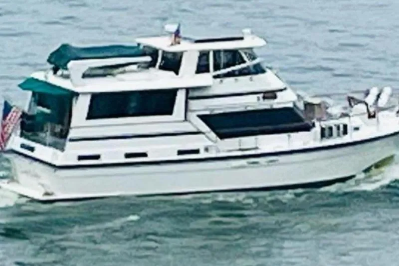 Slide: The Image of 1984 Gulfstar 49 Motor Yacht cruising on open water. - 114