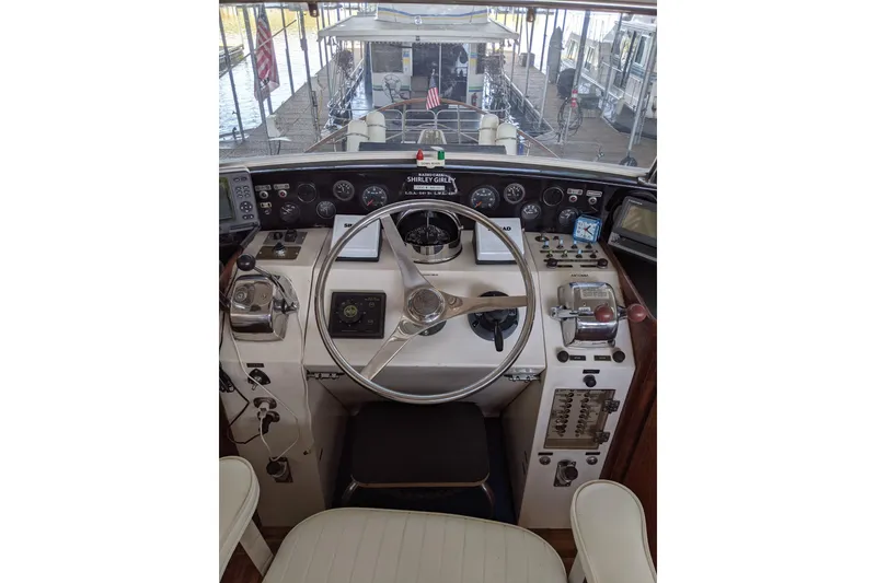 Slide: The Image of Cockpit of 1984 Gulfstar 49 Motor Yacht with steering wheel and control panel. - 12