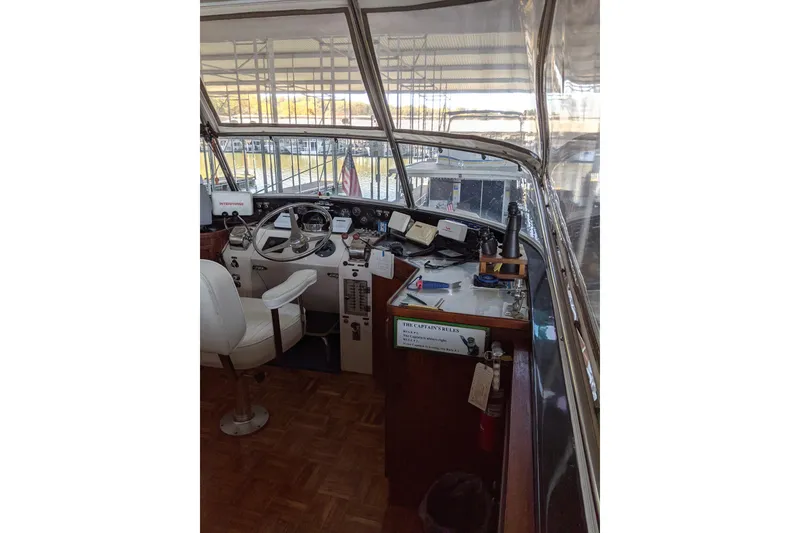 Slide: The Image of 1984 Gulfstar 49 Motor Yacht helm with steering wheel, controls, and navigation equipment. - 13