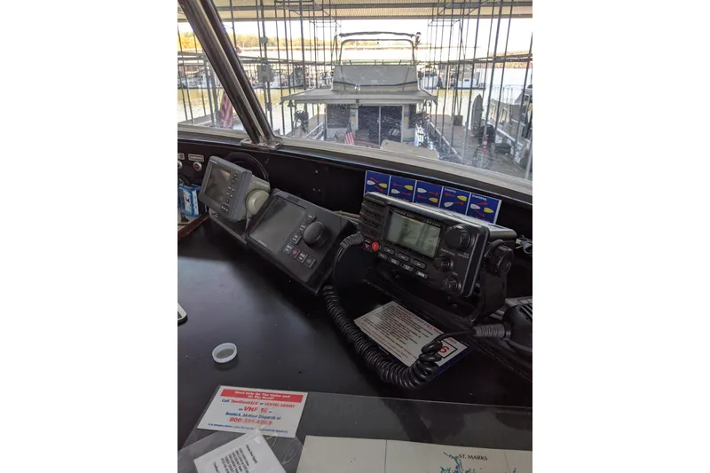 Slide: The Image of 1984 Gulfstar 49 Motor Yacht helm with navigation equipment and marina view. - 16