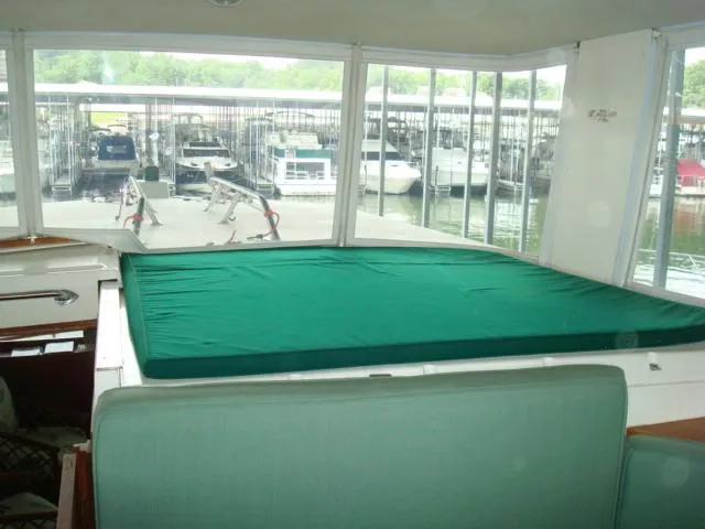 Slide: The Image of 1984 Gulfstar 49 Motor Yacht interior with green cover, docked at marina. - 17