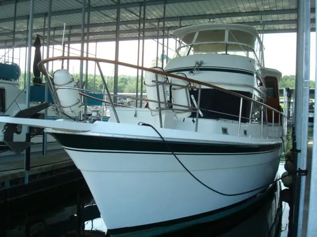 Slide: The Image of 1984 Gulfstar 49 Motor Yacht docked in a covered marina. - 2