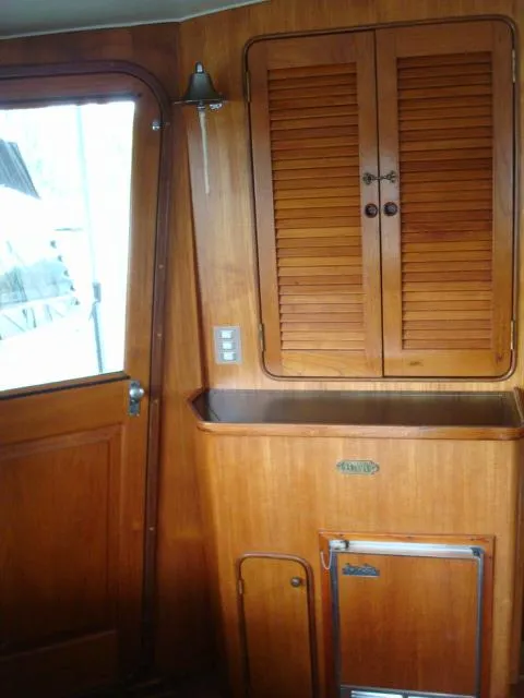 Slide: The Image of 1984 Gulfstar 49 Motor Yacht interior with wooden cabinetry and door. - 21