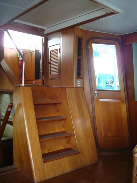 Slide: The Image of 1984 Gulfstar 49 Motor Yacht interior with wooden stairs and door. - 23