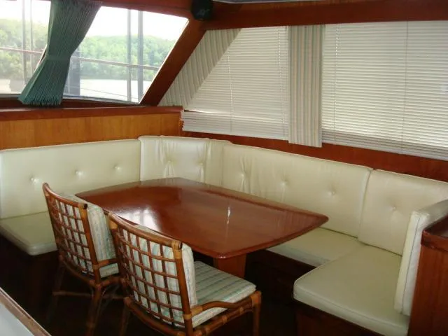 Slide: The Image of Interior of 1984 Gulfstar 49 Motor Yacht with dining area and cushioned seating. - 26