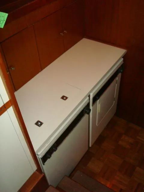 Slide: The Image of Compact kitchen area in a 1984 Gulfstar 49 Motor Yacht with wooden cabinetry. - 27