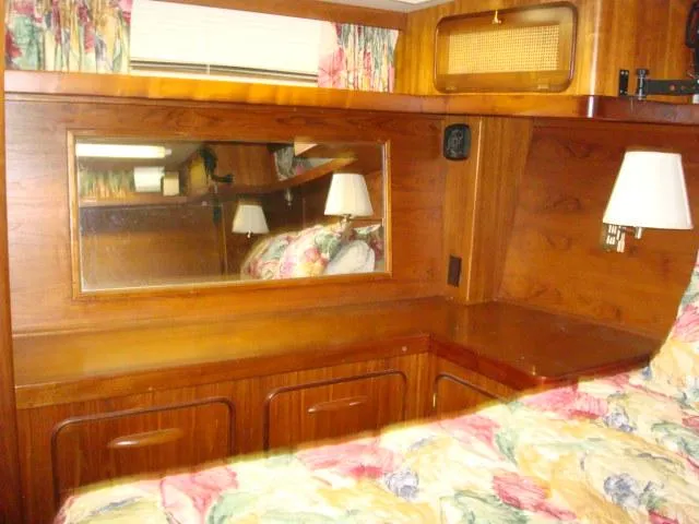Slide: The Image of Interior of 1984 Gulfstar 49 Motor Yacht with wood paneling and floral bedding. - 37