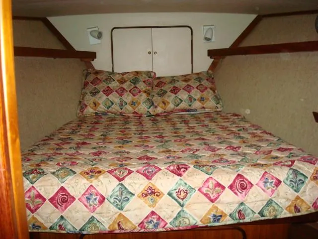 Slide: The Image of Cozy bedroom in 1984 Gulfstar 49 Motor Yacht with colorful quilted bedding. - 41