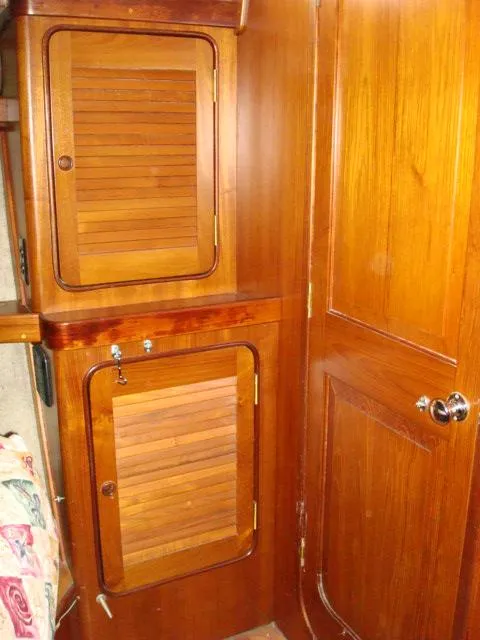 Slide: The Image of 1984 Gulfstar 49 Motor Yacht interior with wooden cabinets and door. - 43