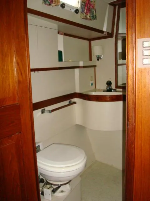 Slide: The Image of 1984 Gulfstar 49 Motor Yacht bathroom with wooden accents and compact design. - 46