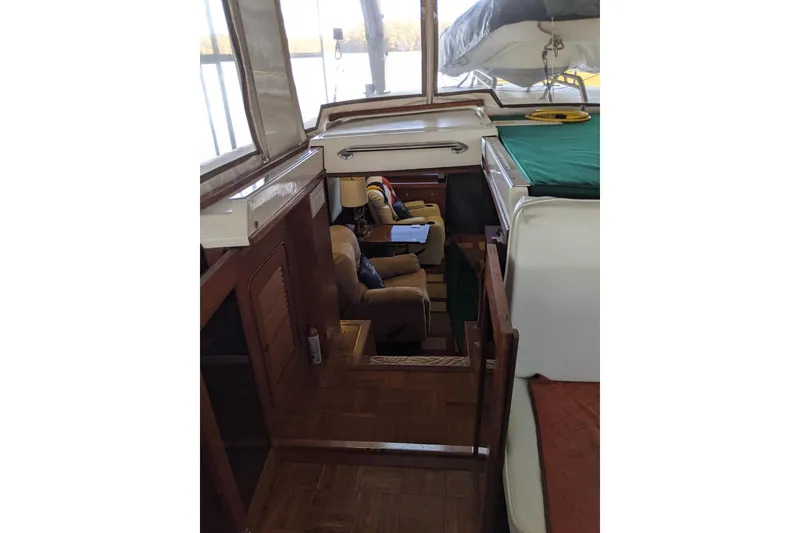 Slide: The Image of Interior view of 1984 Gulfstar 49 Motor Yacht with wooden finishes and seating area. - 47