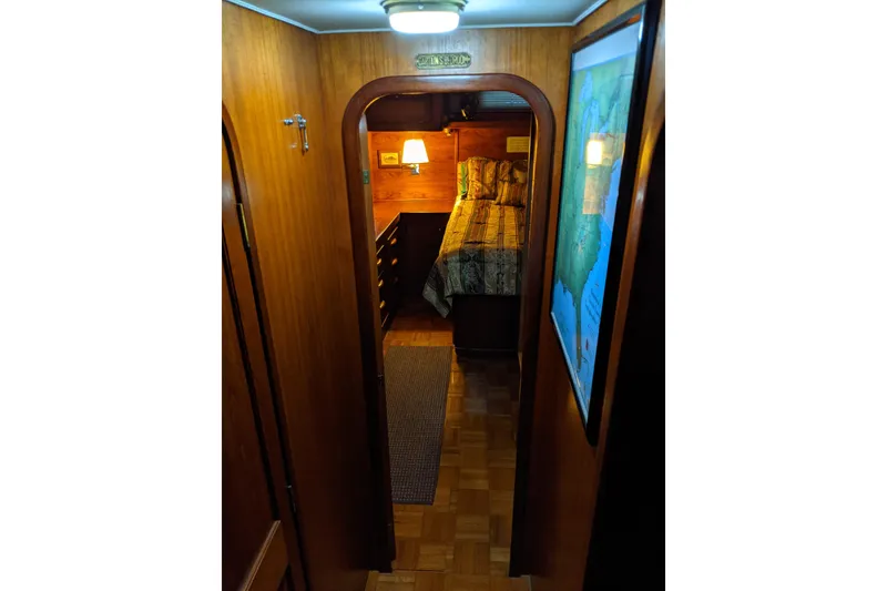 Slide: The Image of Cozy cabin interior of 1984 Gulfstar 49 Motor Yacht with wood paneling and bed. - 48