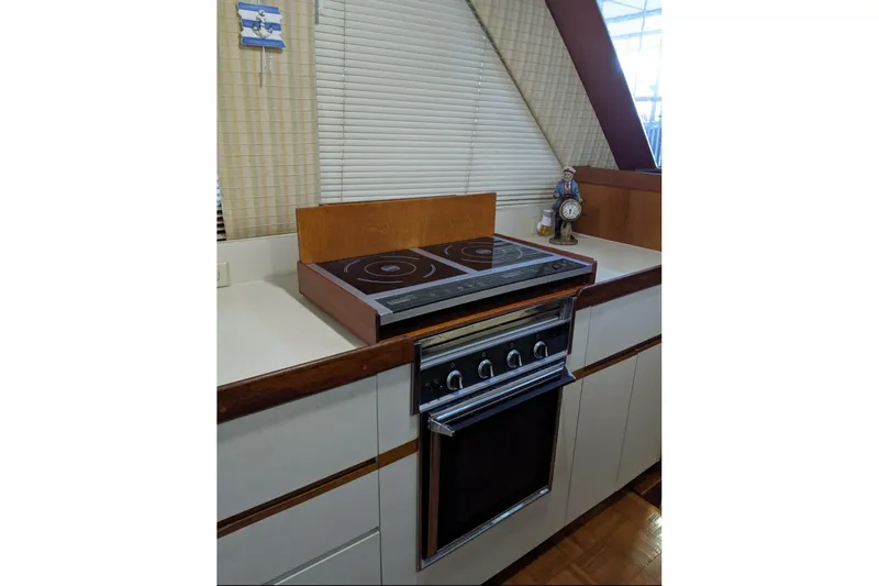 Slide: The Image of 1984 Gulfstar 49 Motor Yacht kitchen with stove and countertop decor. - 51