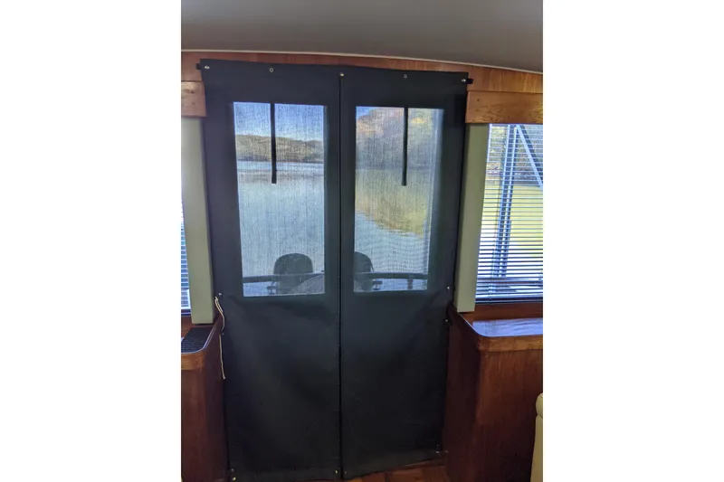 Slide: The Image of Interior view of 1984 Gulfstar 49 Motor Yacht with mesh door and window blinds. - 53