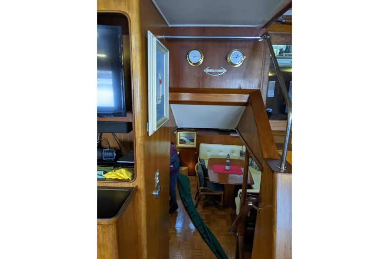 Slide: The Image of Interior of 1984 Gulfstar 49 Motor Yacht with wood paneling and dining area. - 55