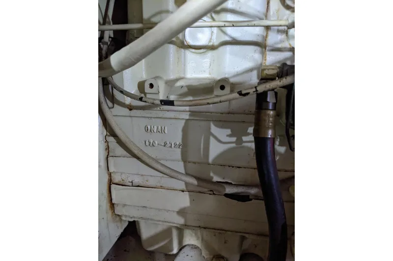 Slide: The Image of Engine compartment of 1984 Gulfstar 49 Motor Yacht, featuring Onan components and wiring. - 67