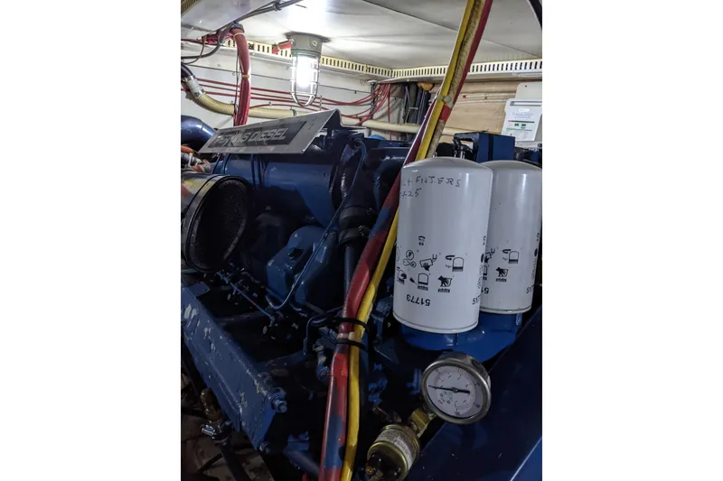 Slide: The Image of Engine room of 1984 Gulfstar 49 Motor Yacht with diesel engine and filters. - 69