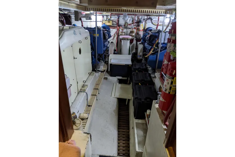 Slide: The Image of Engine room of 1984 Gulfstar 49 Motor Yacht with equipment and fire extinguishers. - 79