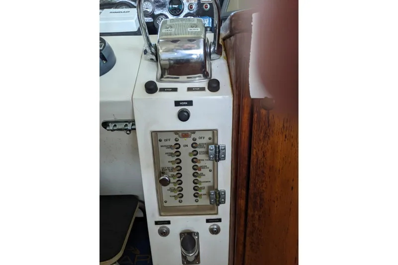 Slide: The Image of Control panel of a 1984 Gulfstar 49 Motor Yacht with switches and gauges. - 8