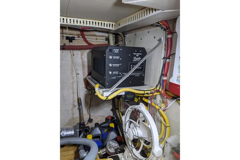 Slide: The Image of Electrical system inside a 1984 Gulfstar 49 Motor Yacht, featuring wiring and equipment. - 85