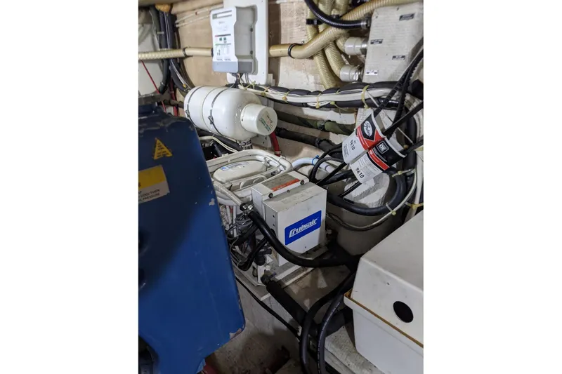 Slide: The Image of Engine room of 1984 Gulfstar 49 Motor Yacht with various equipment and wiring. - 88