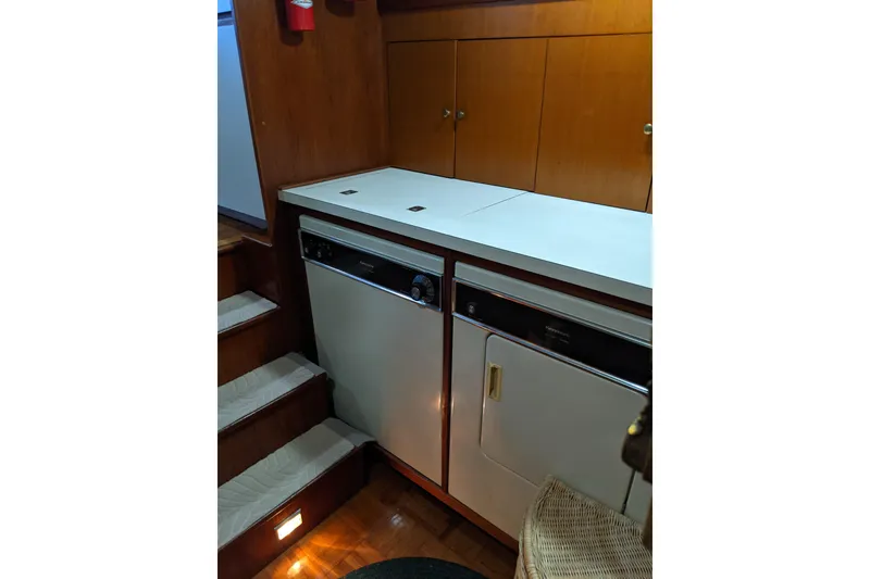 Slide: The Image of 1984 Gulfstar 49 Motor Yacht interior with washer and dryer unit. - 89