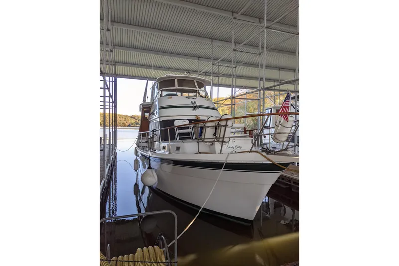 Slide: The Image of 1984 Gulfstar 49 Motor Yacht docked in a covered marina. - 92