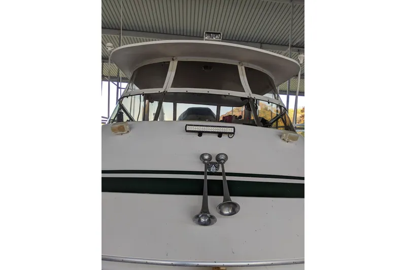 Slide: The Image of 1984 Gulfstar 49 Motor Yacht front view under a covered dock. - 94
