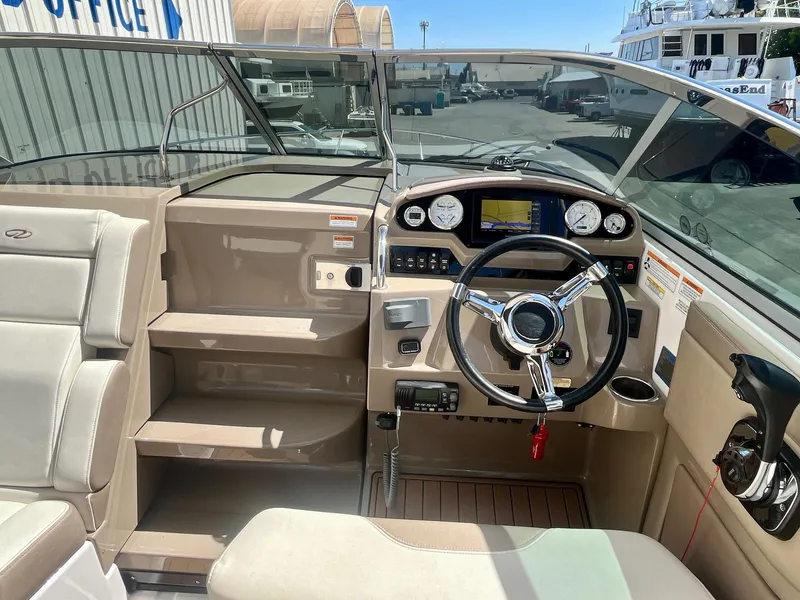 Slide: The Image of 2017 Regal 28 Express boat cockpit with steering wheel and dashboard controls. - 10