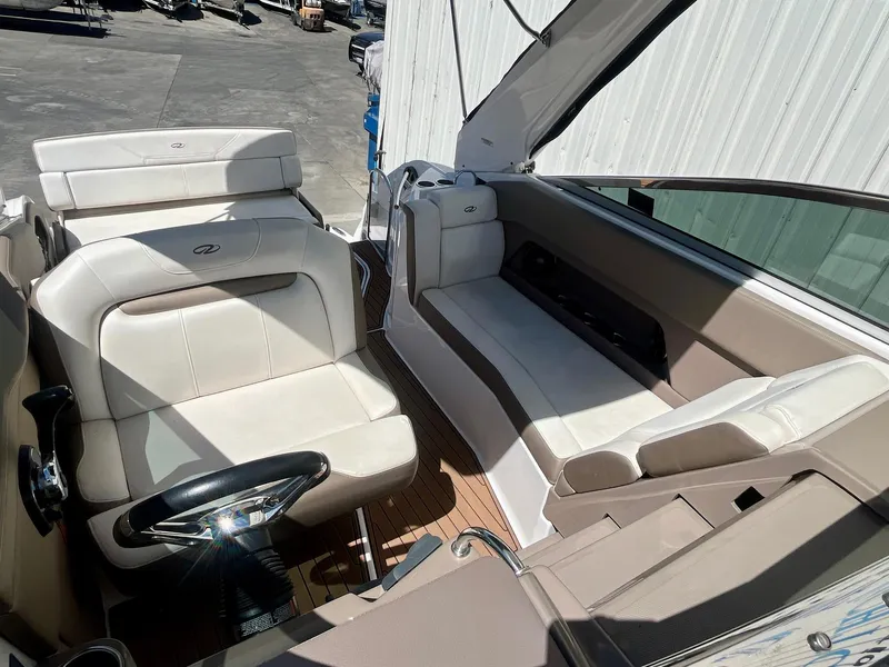 Slide: The Image of 2017 Regal 28 Express boat interior with beige seating and steering wheel. - 12