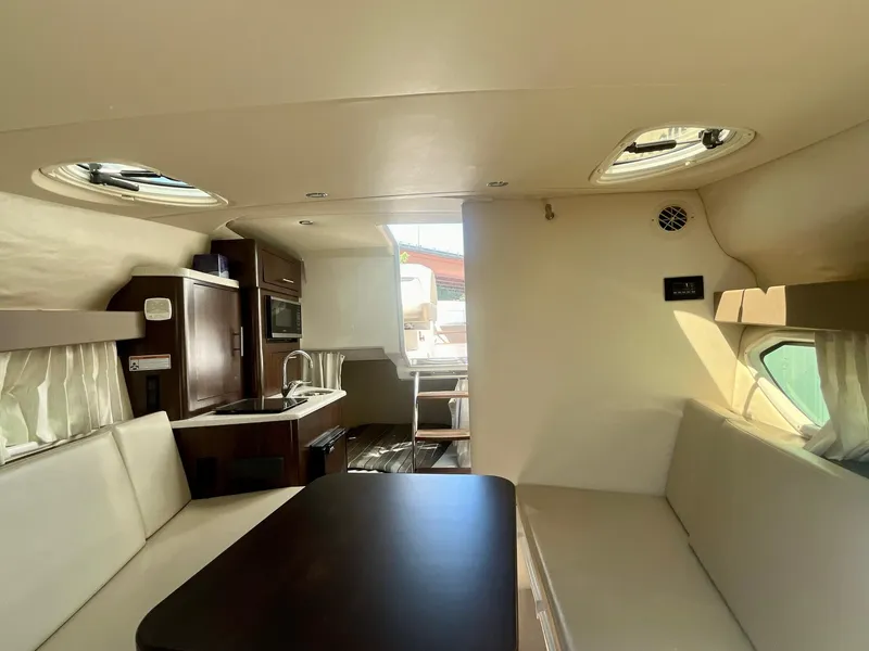 Slide: The Image of Interior of 2017 Regal 28 Express boat with seating and kitchenette. - 14