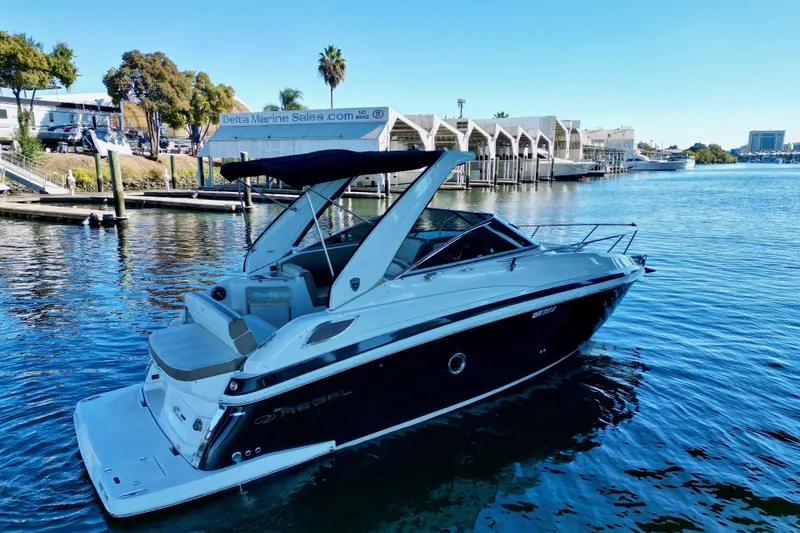Slide: The Image of 2017 Regal 28 Express boat docked at marina, calm water, clear sky. - 3
