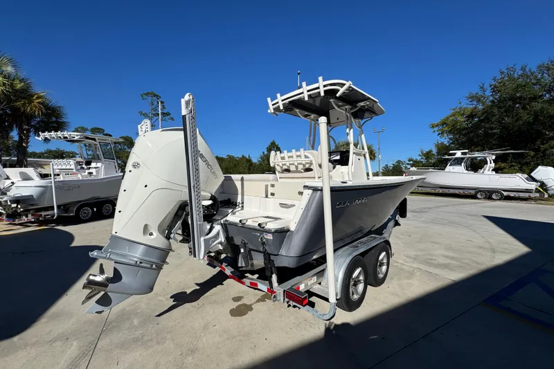 Slide: The Image of 2022 Sea Born LX22 Center Console boat on trailer, outdoor display. - 12