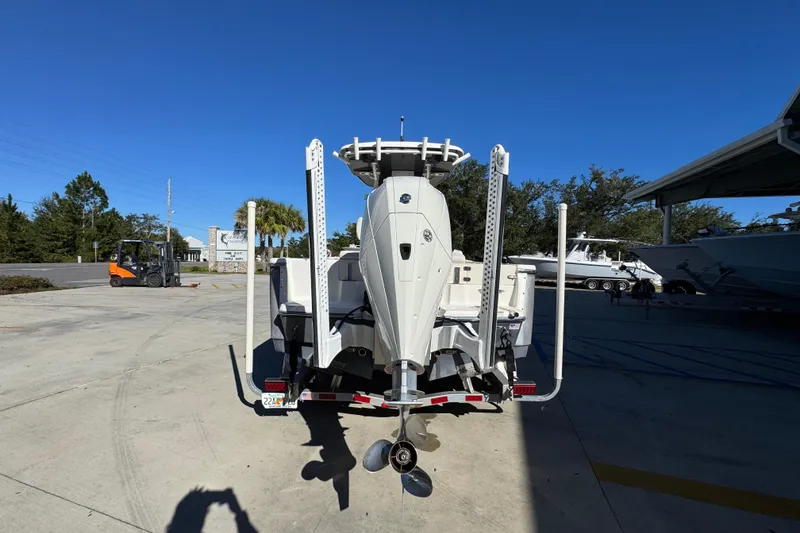 Slide: The Image of 2022 Sea Born LX22 Center Console boat on trailer, rear view in sunny outdoor setting. - 14