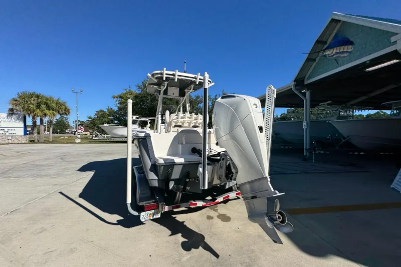 Slide: The Image of 2022 Sea Born LX22 Center Console boat with powerful outboard motor in a sunny marina. - 15