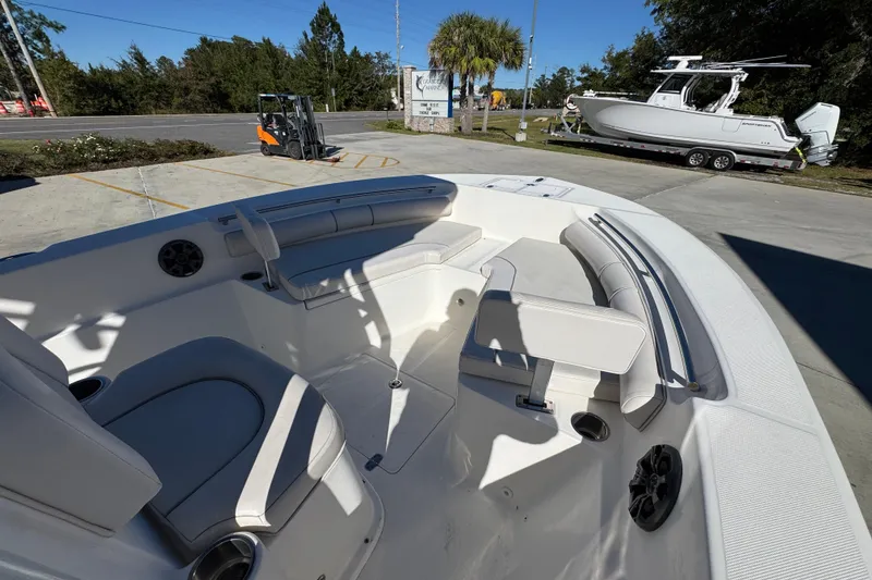 Slide: The Image of 2022 Sea Born LX22 Center Console boat interior with seating and speakers. - 18