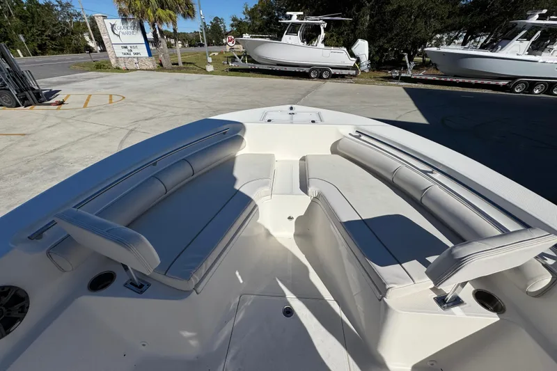 Slide: The Image of 2022 Sea Born LX22 Center Console boat with spacious seating in a sunny marina. - 19
