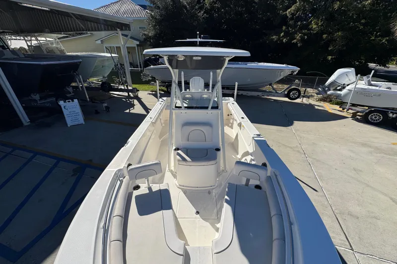 Slide: The Image of 2022 Sea Born LX22 Center Console boat displayed at a marina. - 22