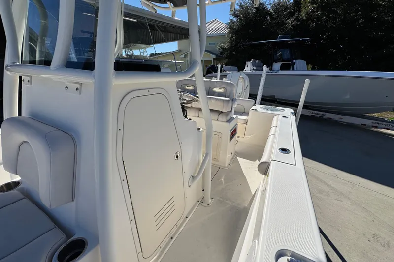 Slide: The Image of 2022 Sea Born LX22 Center Console boat interior with seating and storage compartments. - 25