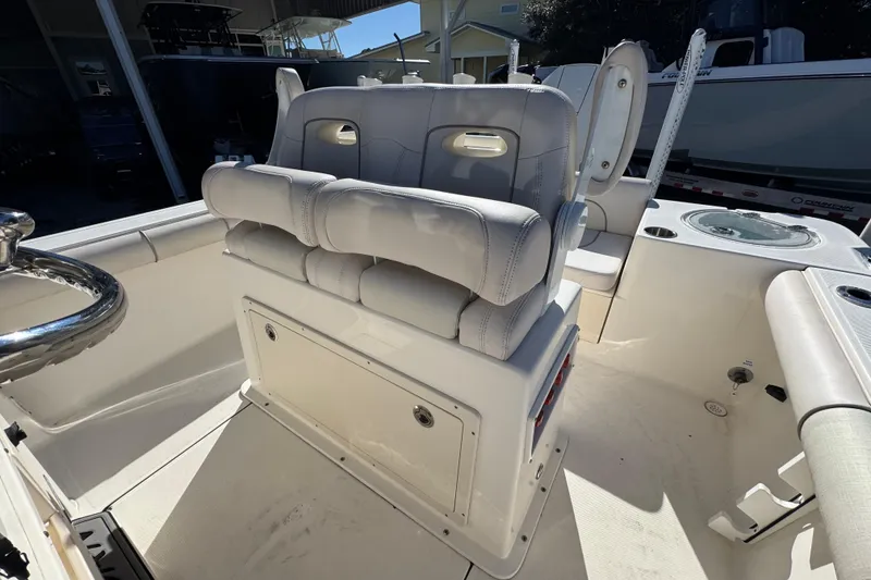 Slide: The Image of 2022 Sea Born LX22 Center Console boat interior with cushioned seating and steering wheel. - 29