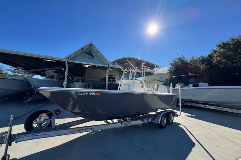 Slide: The Image of 2022 Sea Born LX22 Center Console boat on trailer under sunny sky. - 3