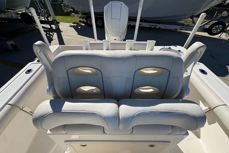 Slide: The Image of 2022 Sea Born LX22 Center Console boat with cushioned seating and rod holders. - 30