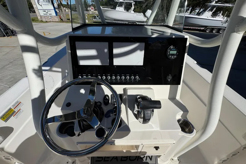 Slide: The Image of 2022 Sea Born LX22 Center Console boat dashboard with steering wheel and controls. - 31
